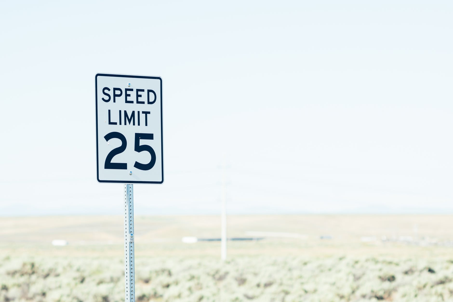 sign on roadside with speed limit